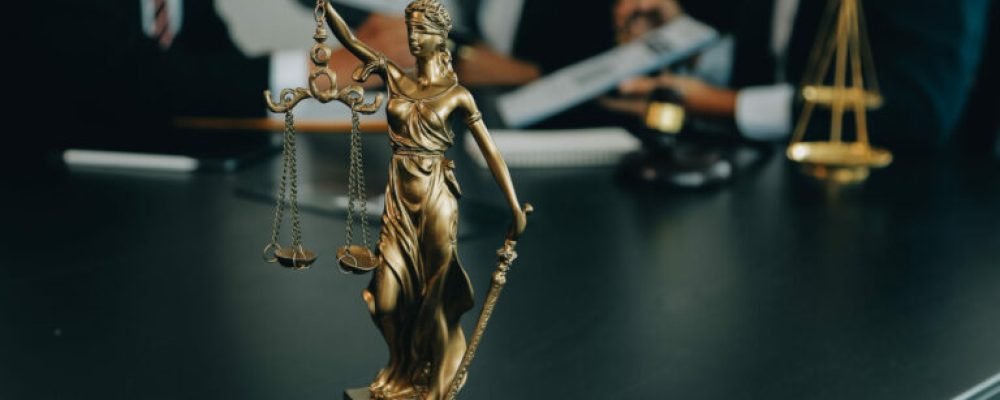 Judge gavel with Justice lawyers having team meeting at law firm background. Concepts of Law and Legal services.