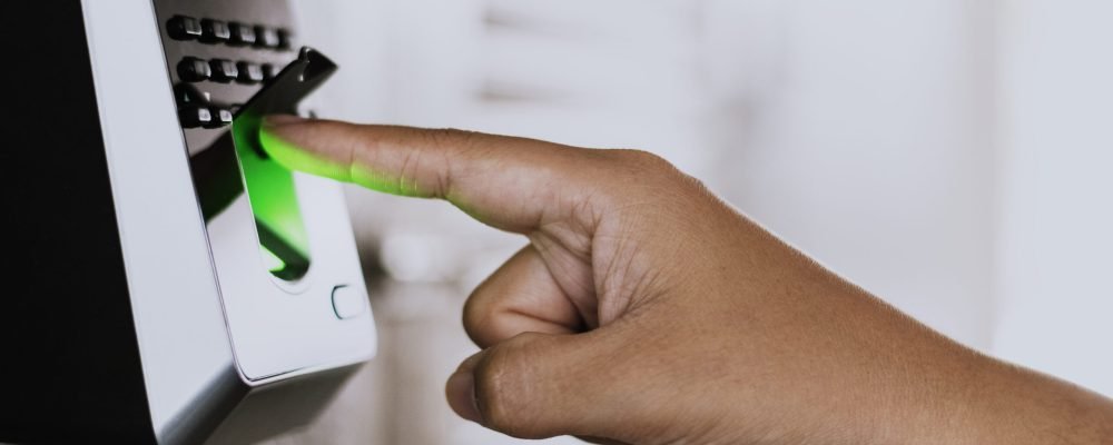 Scanning finger on a coronavirus contaminated fingerprint access control