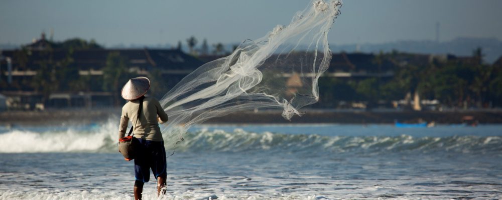a man is fishing with a net. high quality photo